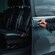 A private driver opening the door of a luxury minivan